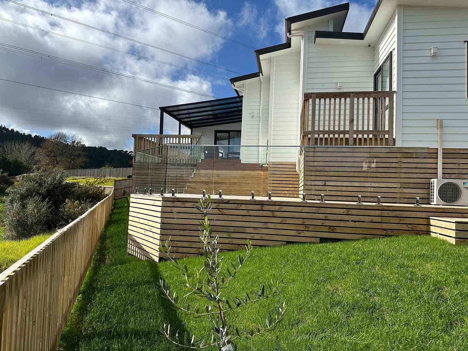 Retaining wall, deck with balustrade, fence and roll-out lawns - by Elysion.