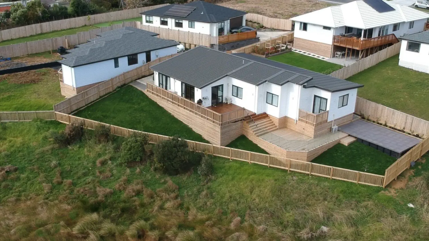 A custom-built timber deck beside a landscaped garden.