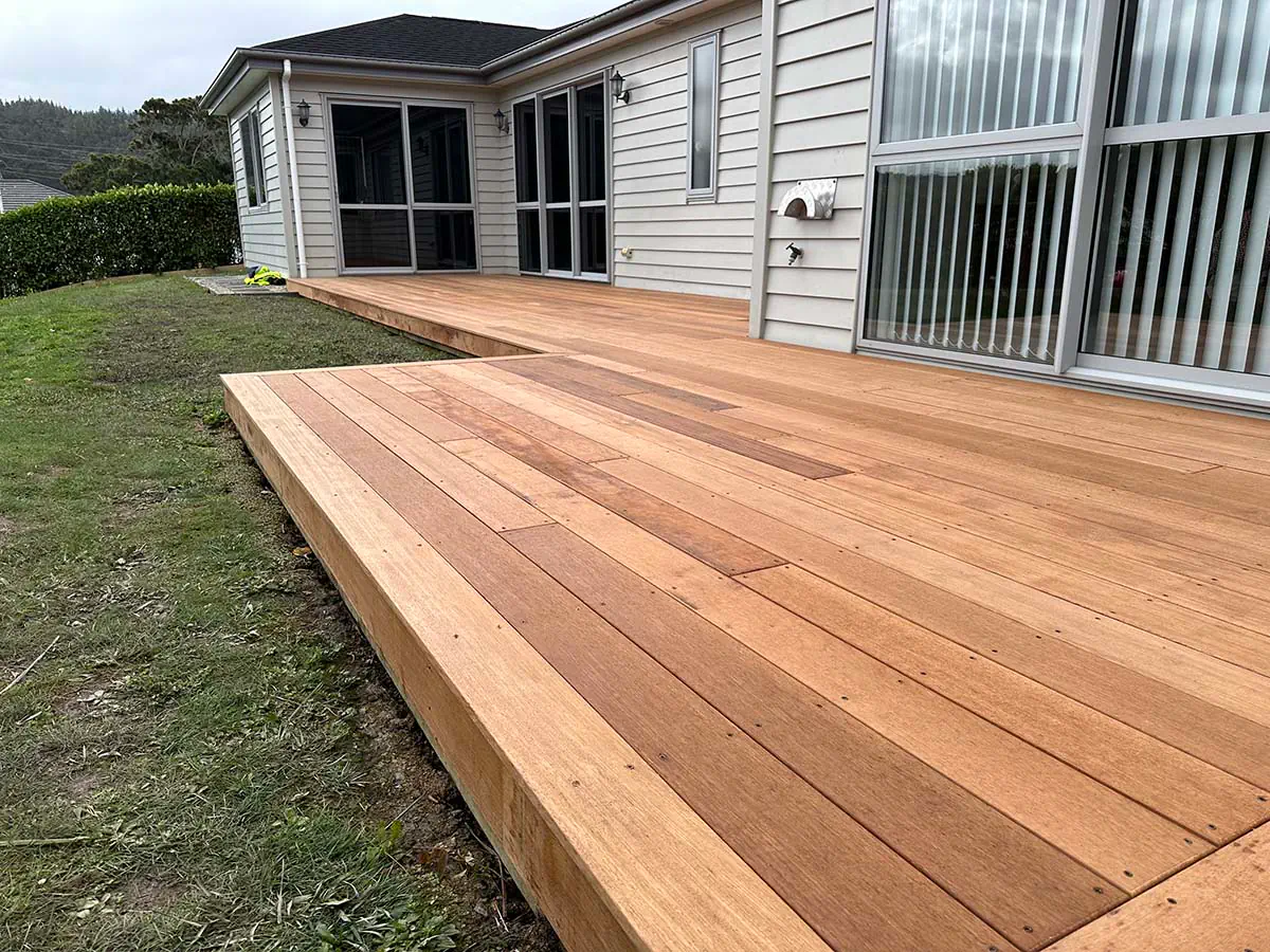 Stone steps bordered by manicured plants and walls.